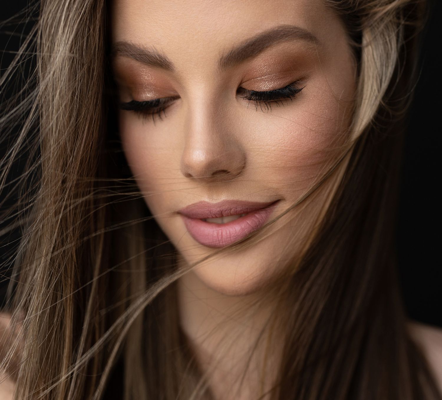 Close-up of a woman's serene face and hair.